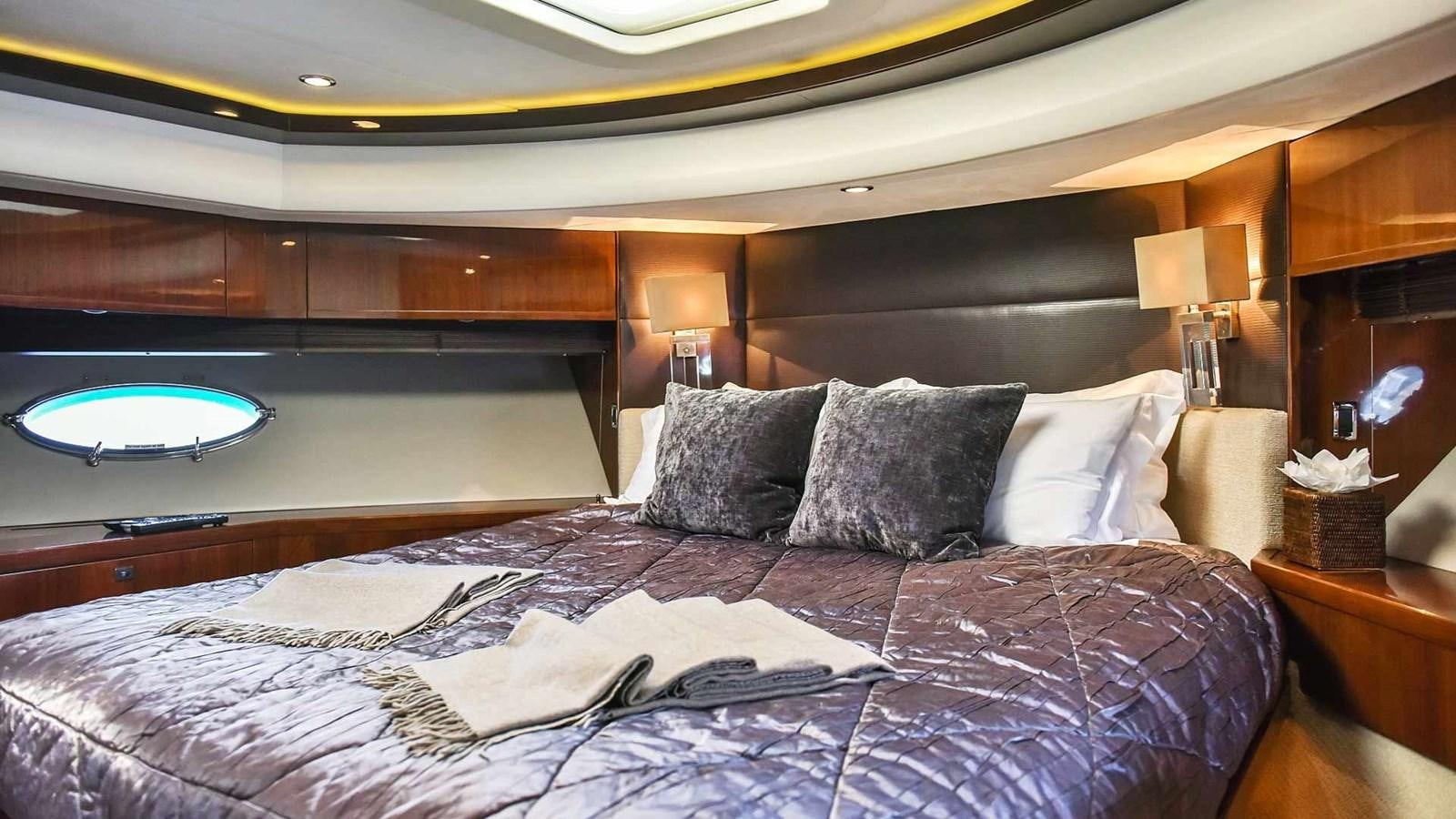 a bed with a purple comforter aboard AGAVE Yacht for Sale