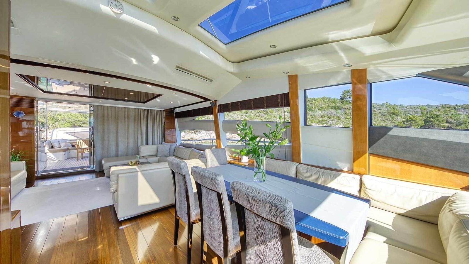 a room with a table chairs and a plant in it aboard AGAVE Yacht for Sale