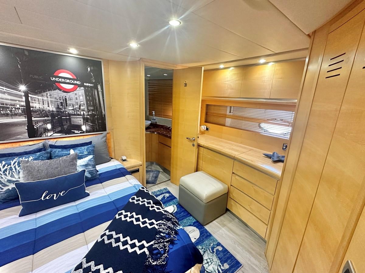 a room with a bed and a tv aboard NOTORIUS Yacht for Sale