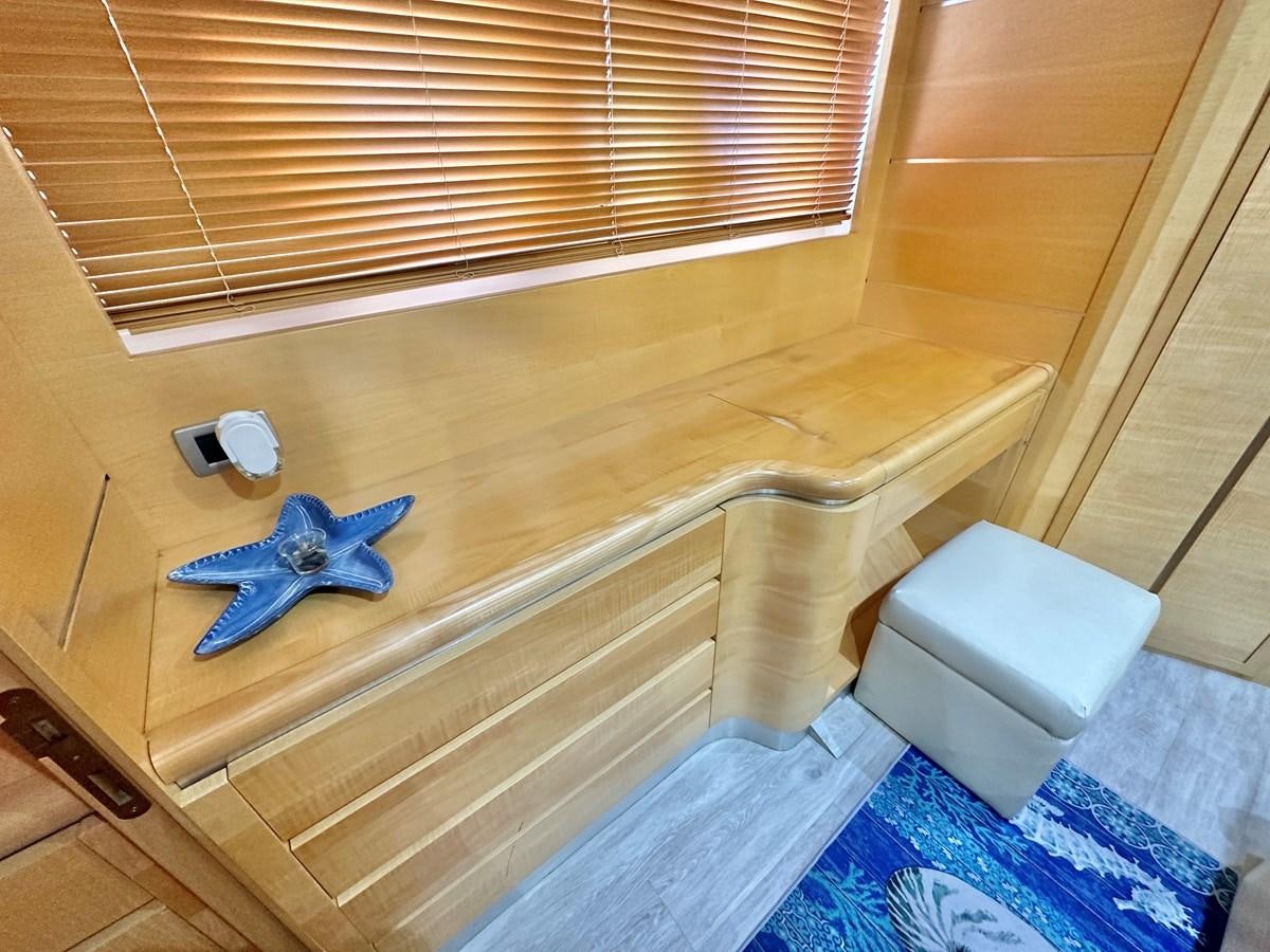 a blue toy dragon on a wooden bench aboard NOTORIUS Yacht for Sale