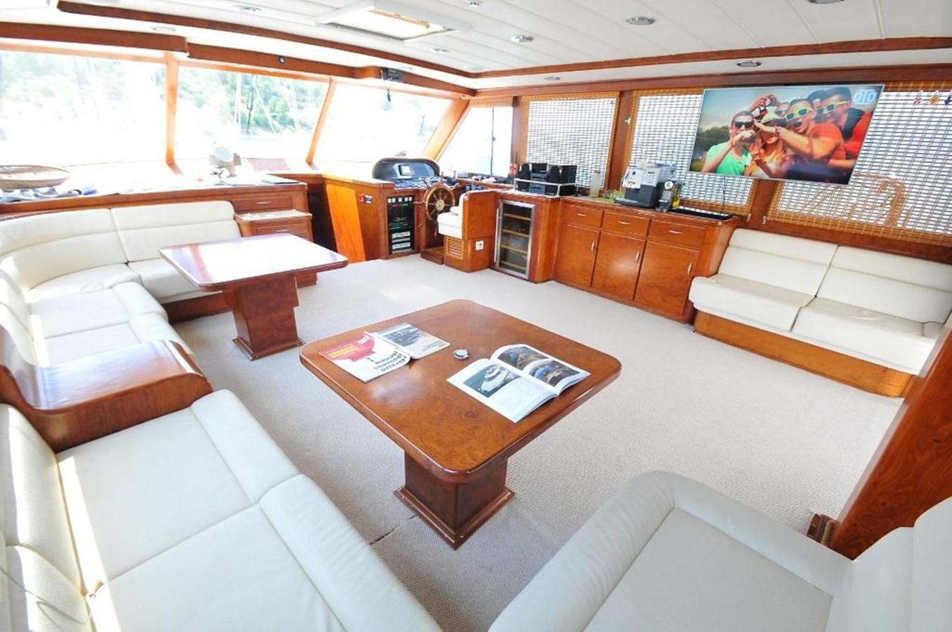 a room with a table and couches aboard EUPH Yacht for Sale
