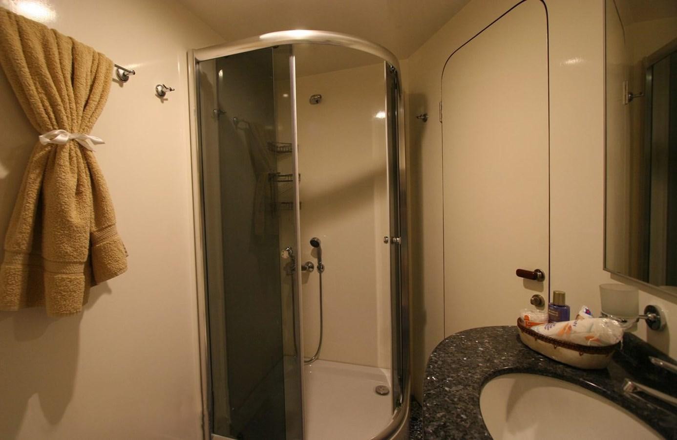 a bathroom with a glass shower aboard EUPH Yacht for Sale