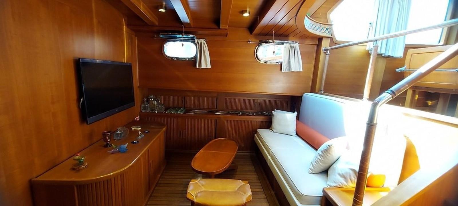 a room with a bed and a tv aboard SYY Yacht for Sale