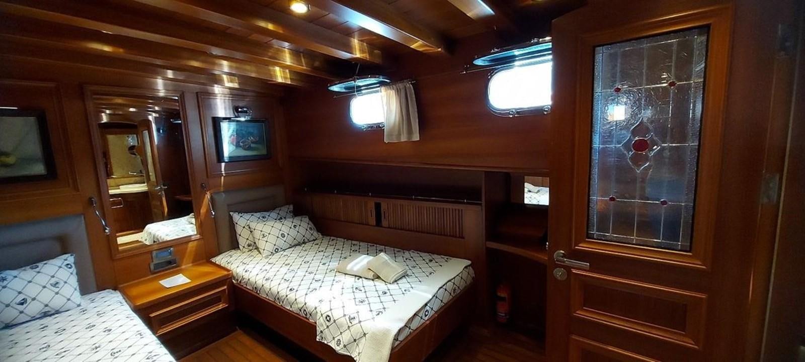 a room with a bed and a window aboard SYY Yacht for Sale