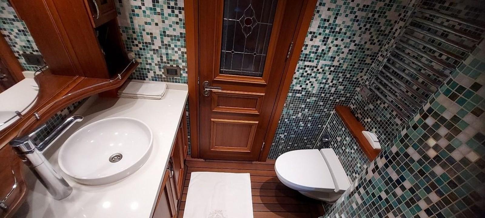 a bathroom with a sink and a toilet aboard SYY Yacht for Sale
