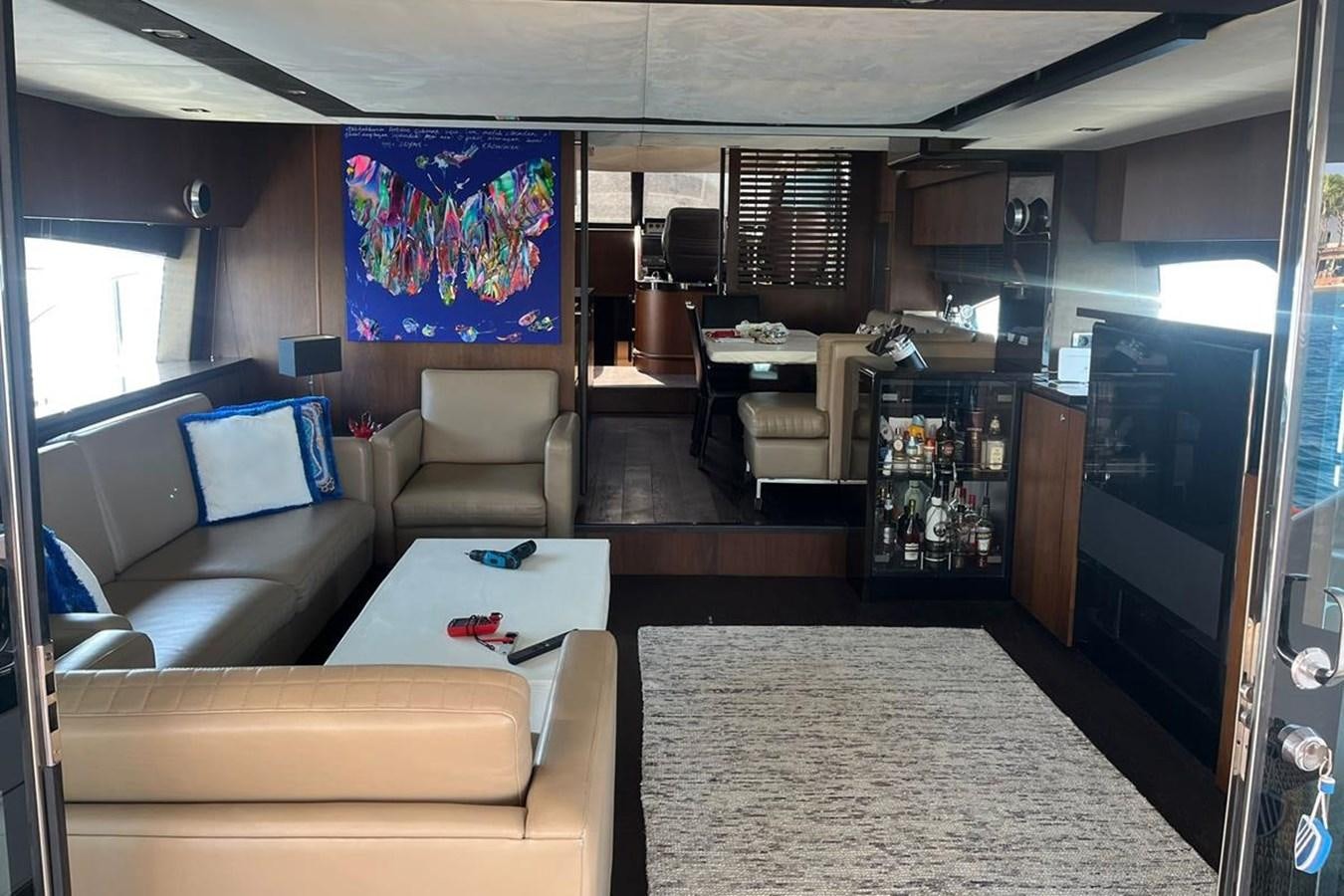 a living room with a large screen aboard FAIRLINE SQUADRON 78 2015 Yacht for Sale
