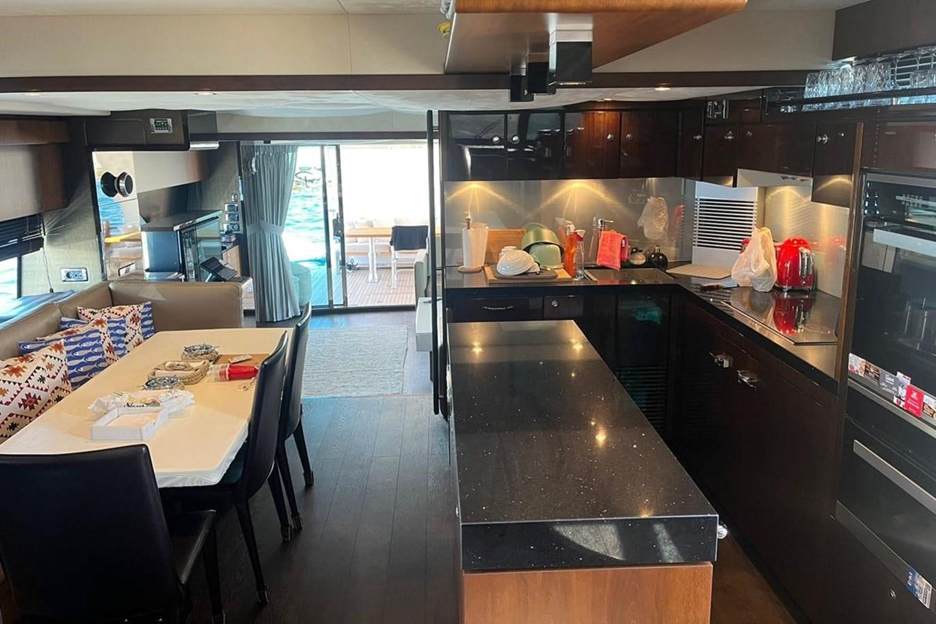 a kitchen with black counters aboard FAIRLINE SQUADRON 78 2015 Yacht for Sale