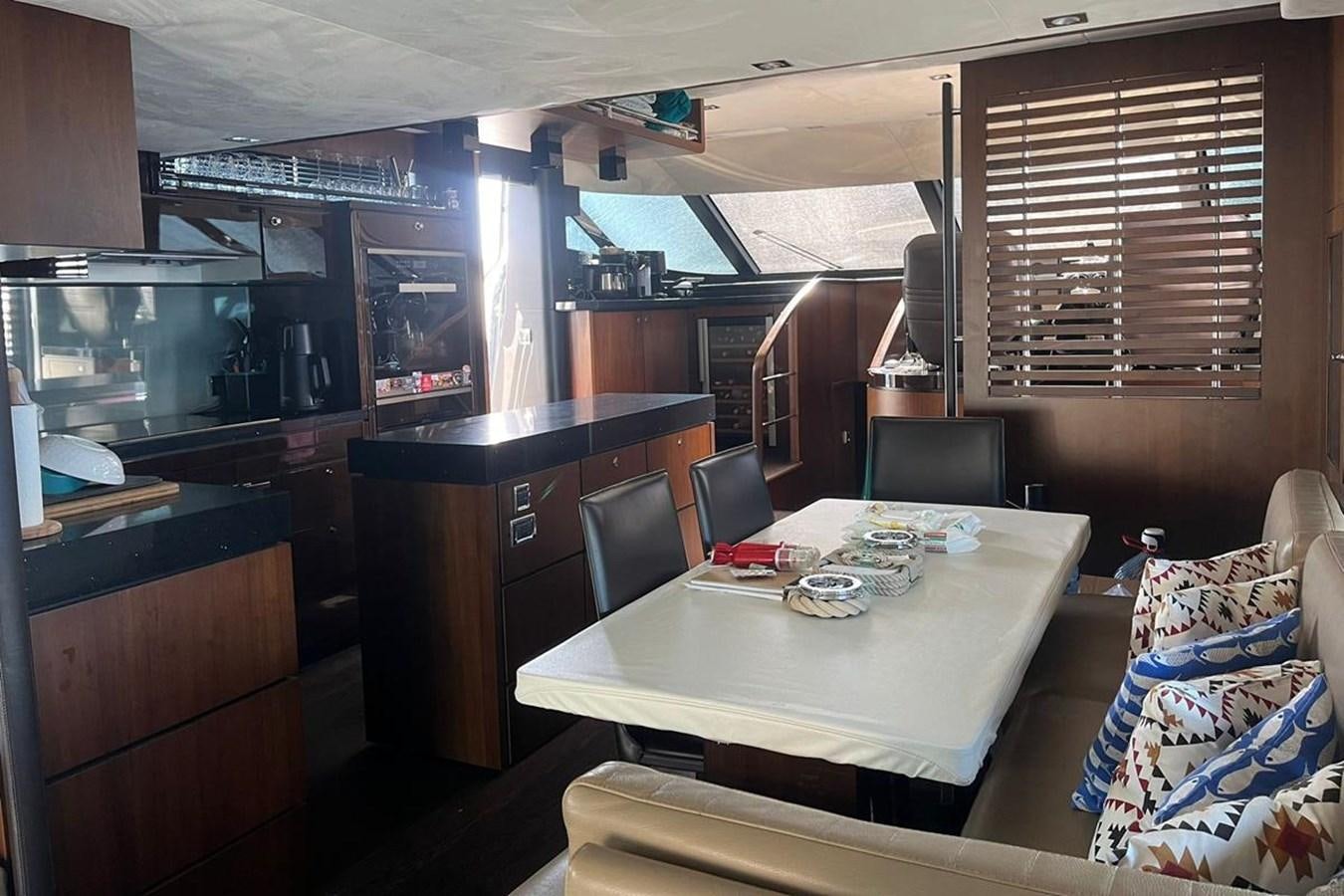 a kitchen with a table and chairs aboard FAIRLINE SQUADRON 78 2015 Yacht for Sale