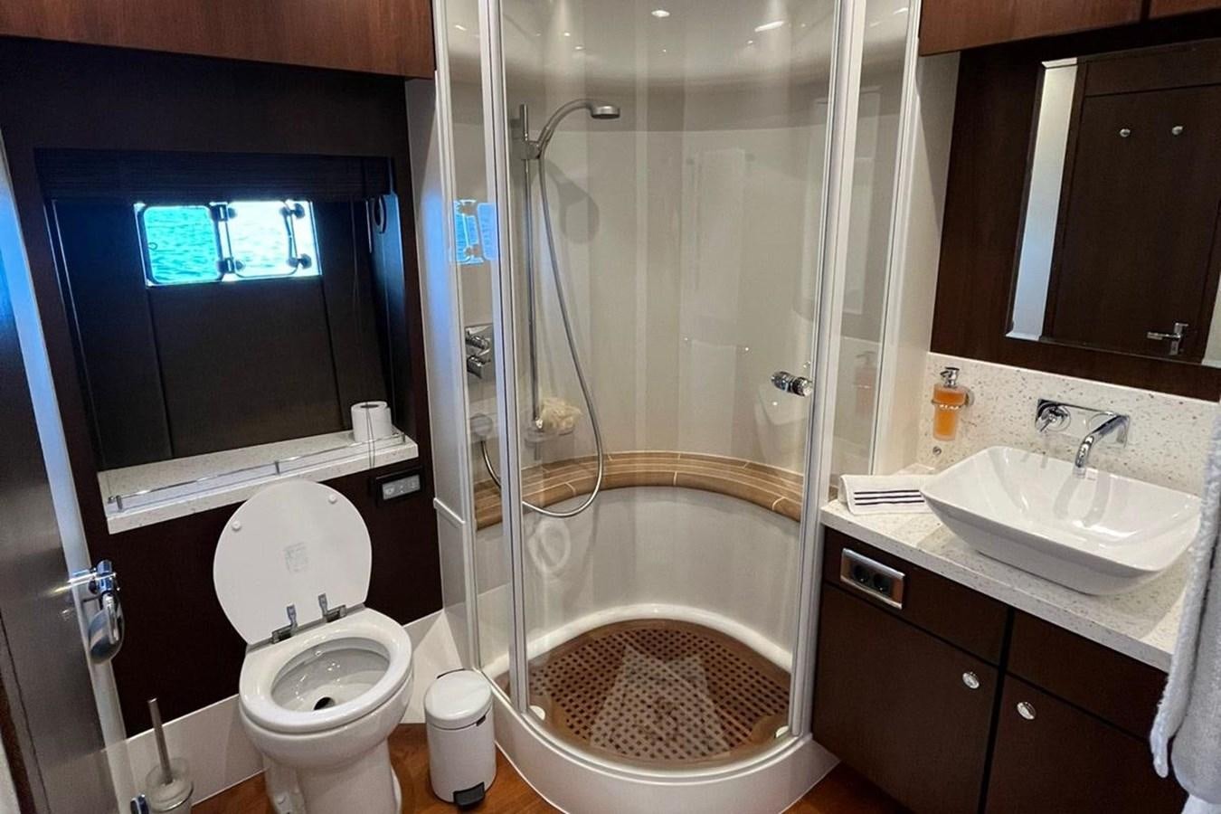 a bathroom with a glass shower aboard FAIRLINE SQUADRON 78 2015 Yacht for Sale