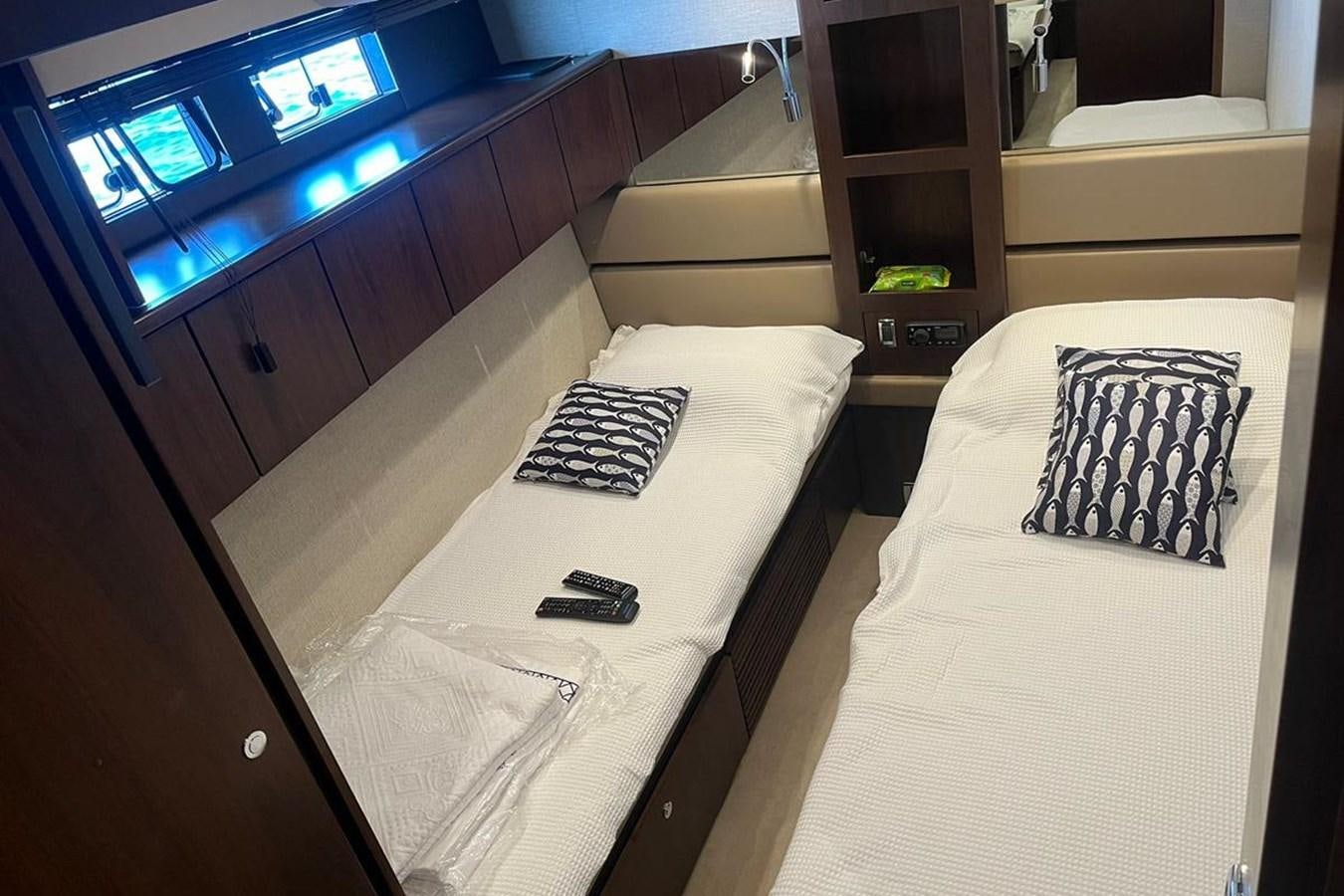 a room with a bed and a shelf with a tv on it aboard FAIRLINE SQUADRON 78 2015 Yacht for Sale