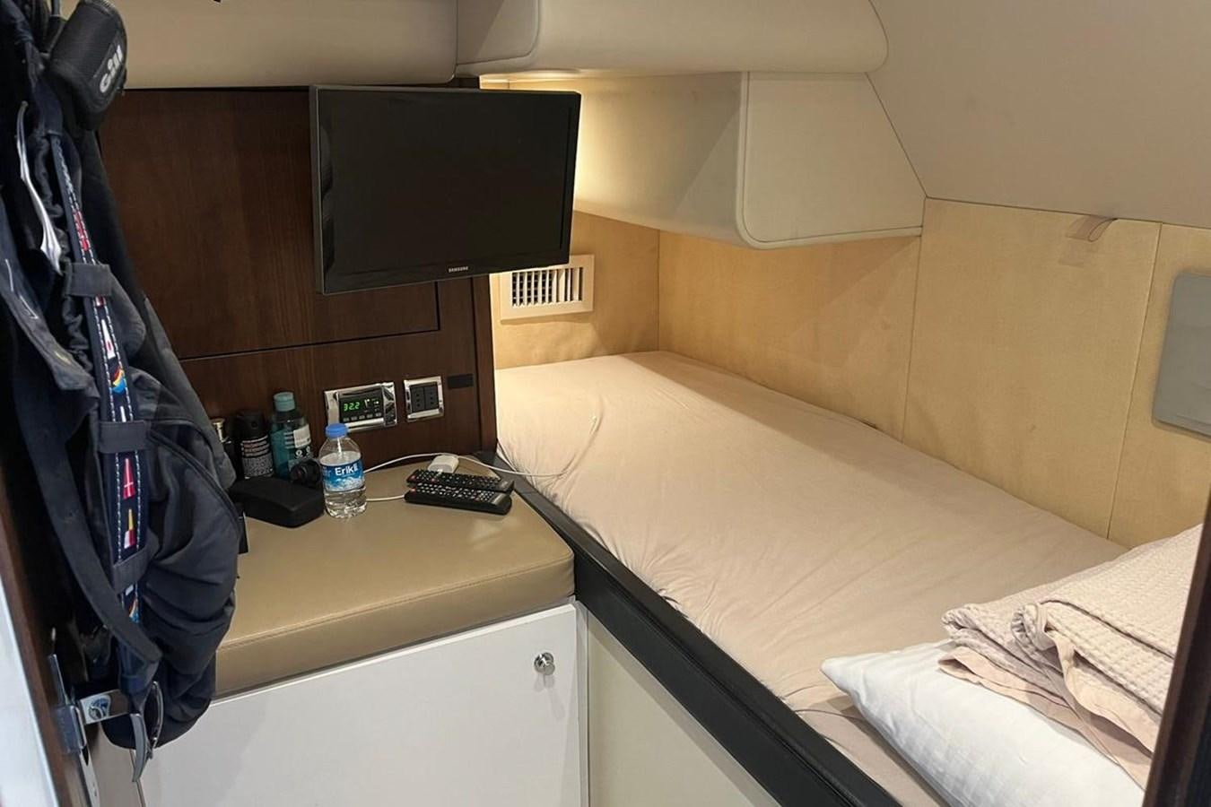 a bed with a television on it aboard FAIRLINE SQUADRON 78 2015 Yacht for Sale