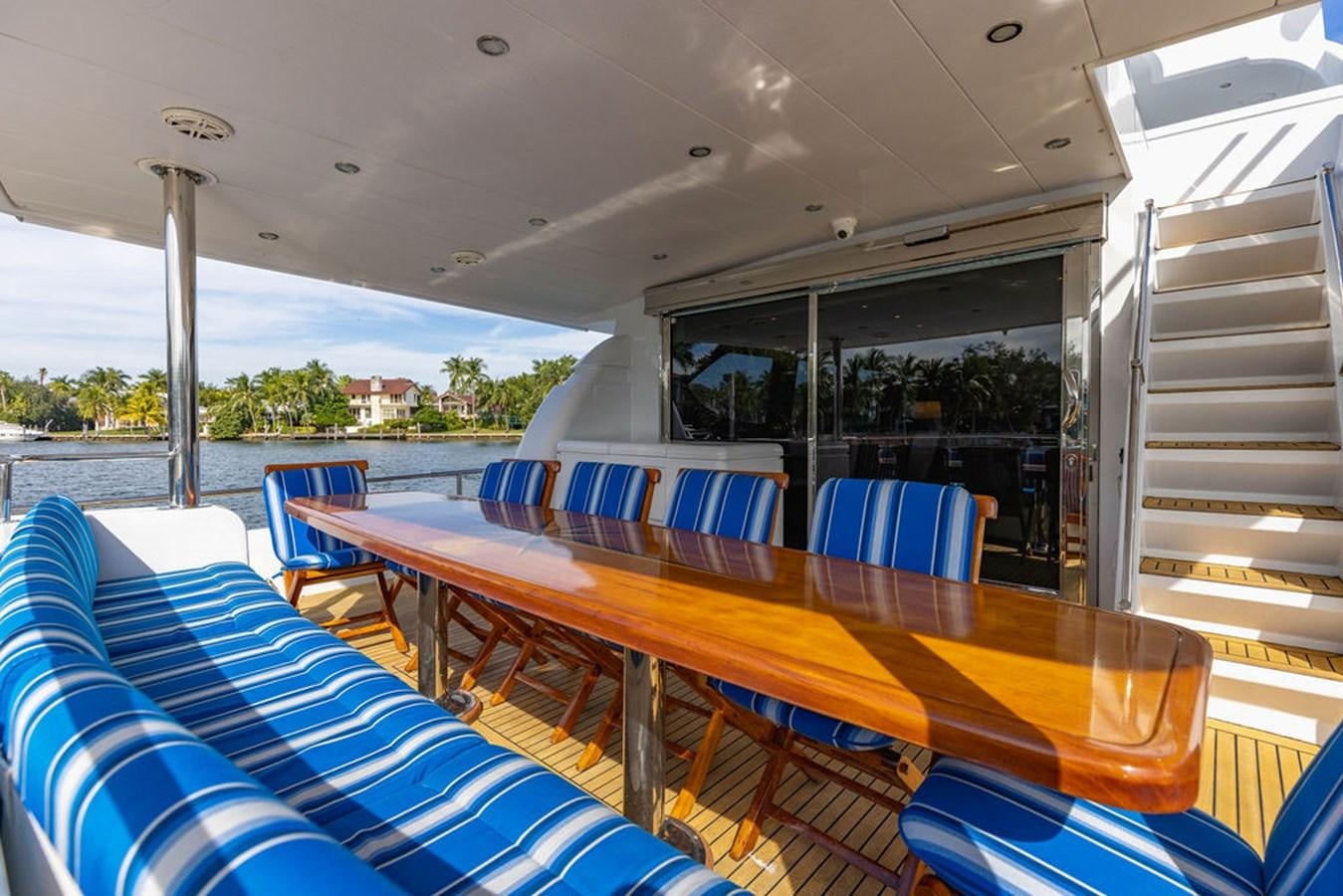 a large room with a table and chairs aboard NO REGRETS Yacht for Sale