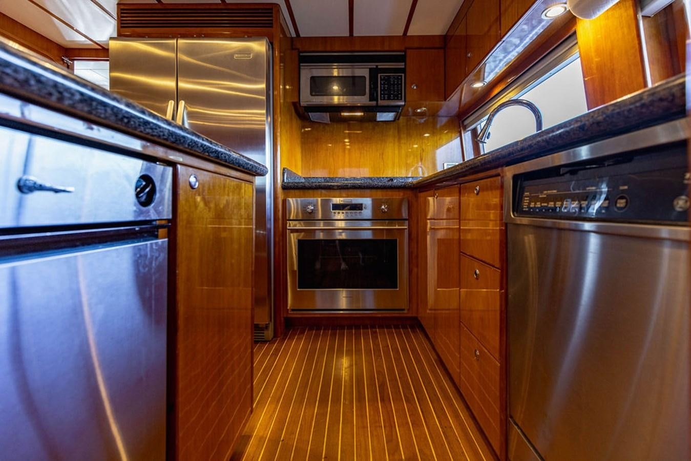 a kitchen with wooden cabinets aboard NO REGRETS Yacht for Sale