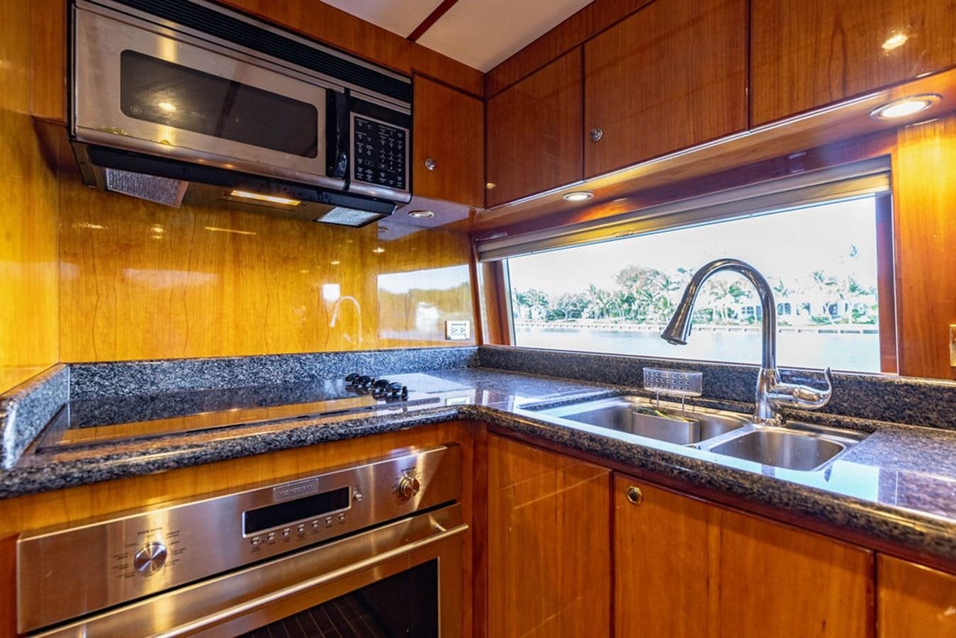 a kitchen with wooden cabinets aboard NO REGRETS Yacht for Sale