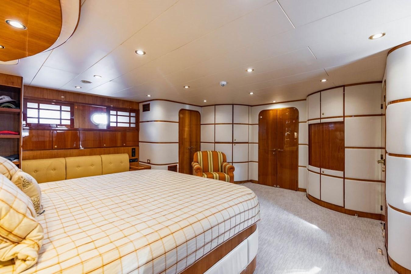 a large bedroom with a bed aboard NO REGRETS Yacht for Sale