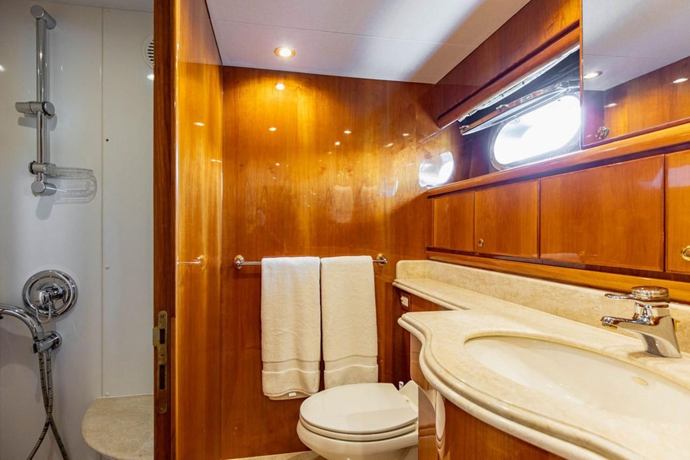 a bathroom with wooden cabinets aboard NO REGRETS Yacht for Sale
