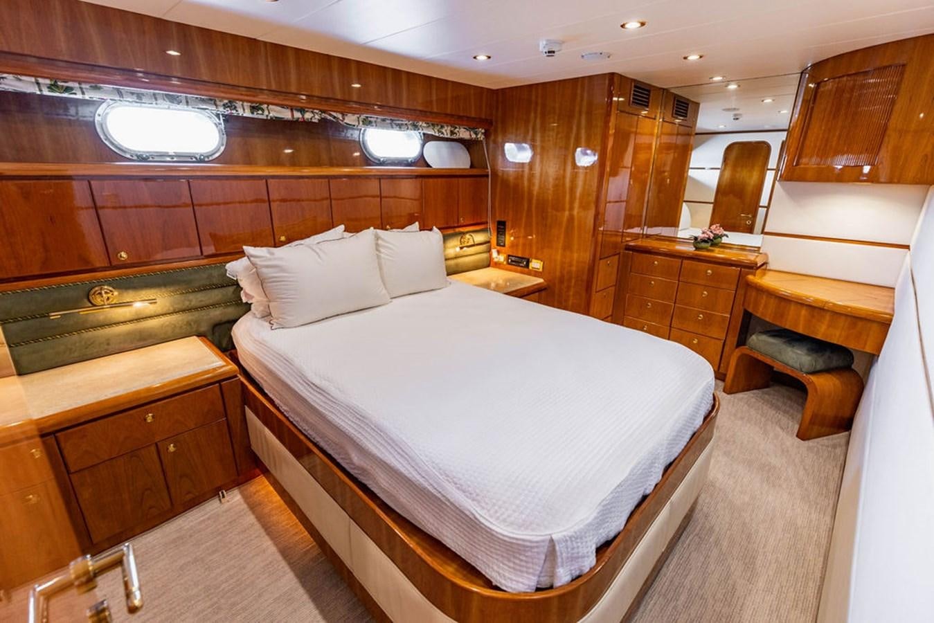 a room with a bed and a desk aboard NO REGRETS Yacht for Sale