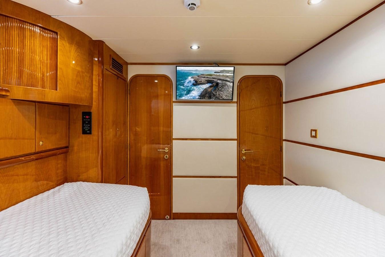 a room with a bed and a wood door aboard NO REGRETS Yacht for Sale