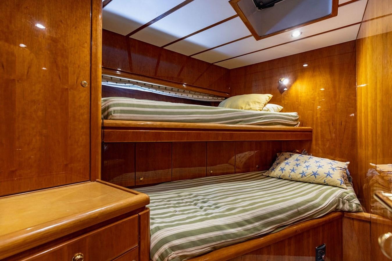 a bed with a wooden headboard aboard NO REGRETS Yacht for Sale