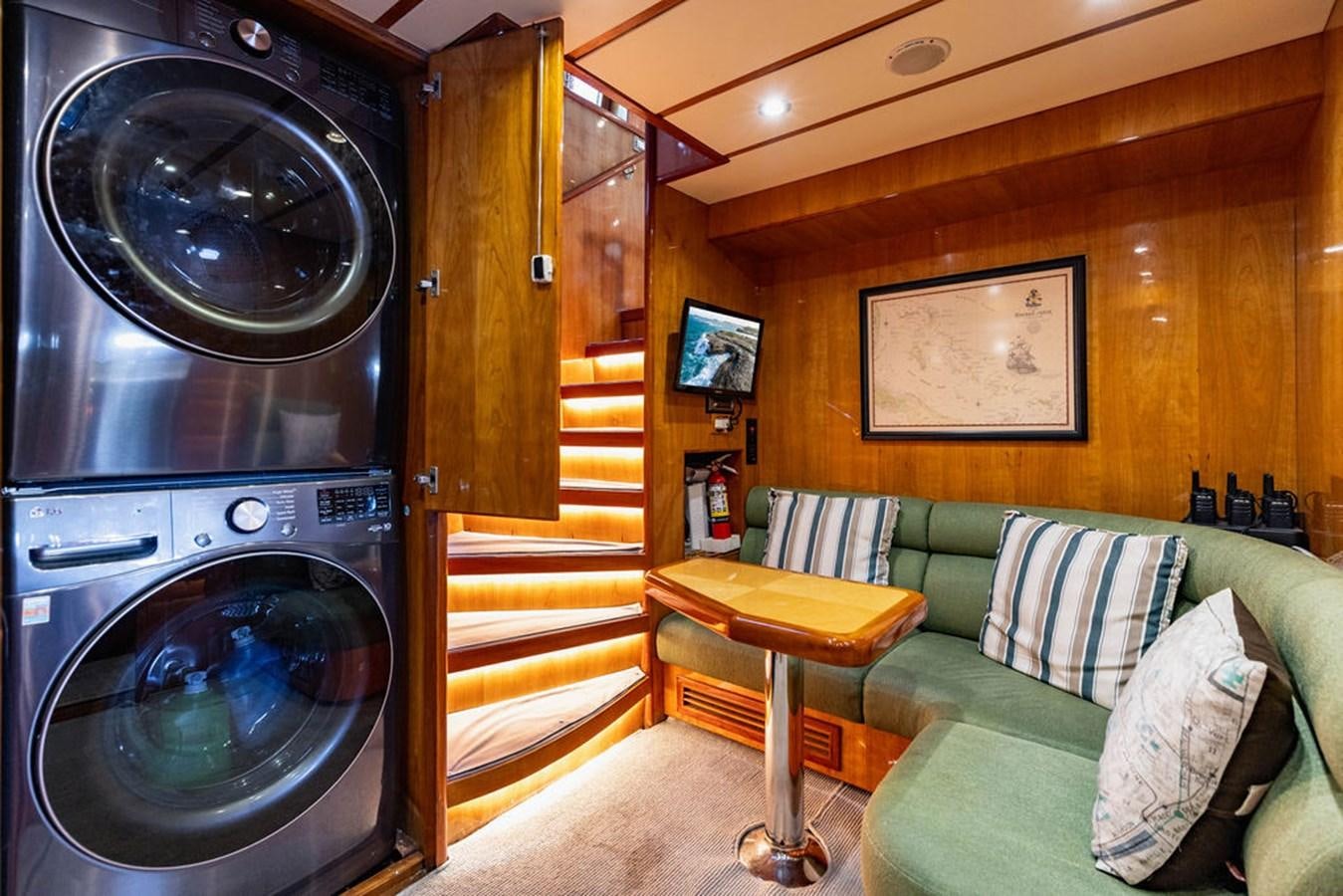 a living room with a couch and a fireplace aboard NO REGRETS Yacht for Sale