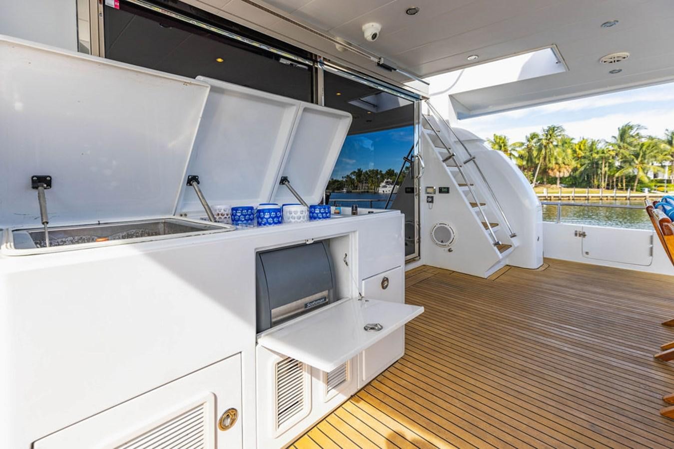 a room with a tv and a large window aboard NO REGRETS Yacht for Sale