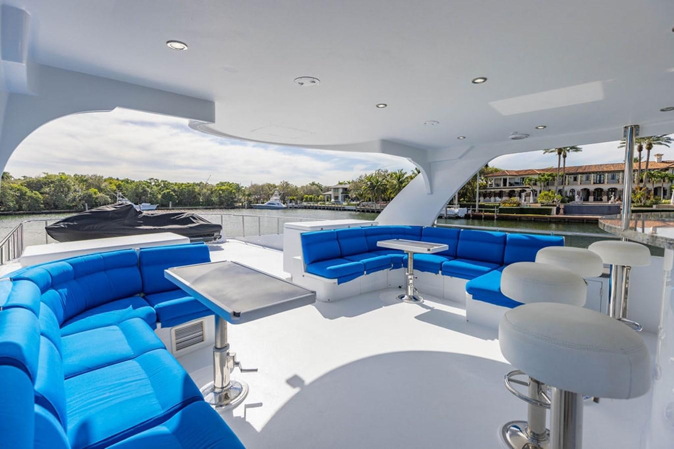 a room with a pool and a mountain in the background aboard NO REGRETS Yacht for Sale