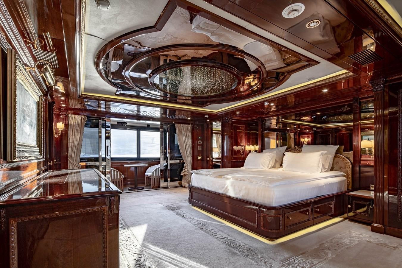 a large bedroom with a large chandelier aboard RICHAR Yacht for Sale