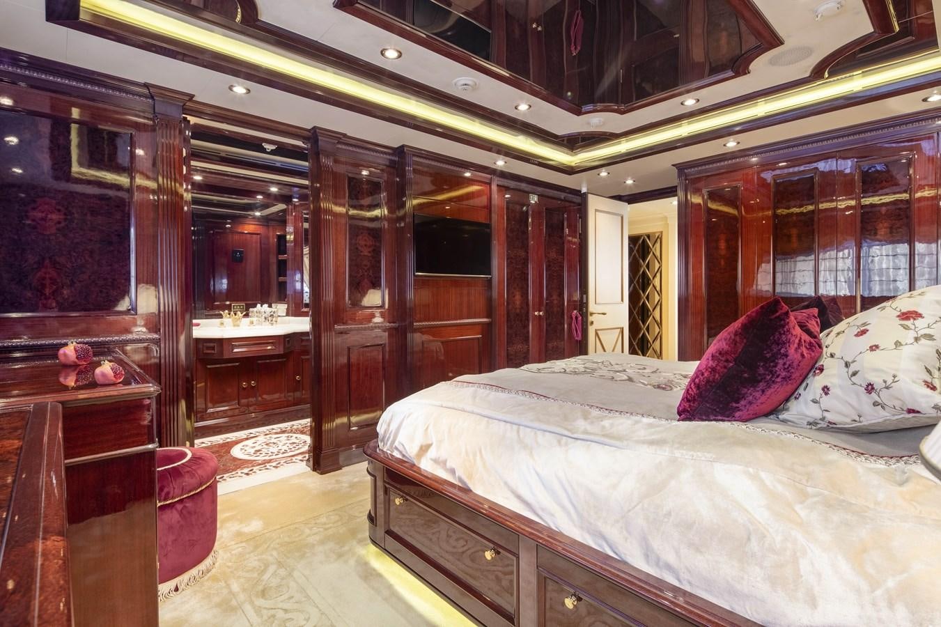 a bedroom with a bed and a mirror aboard RICHAR Yacht for Sale