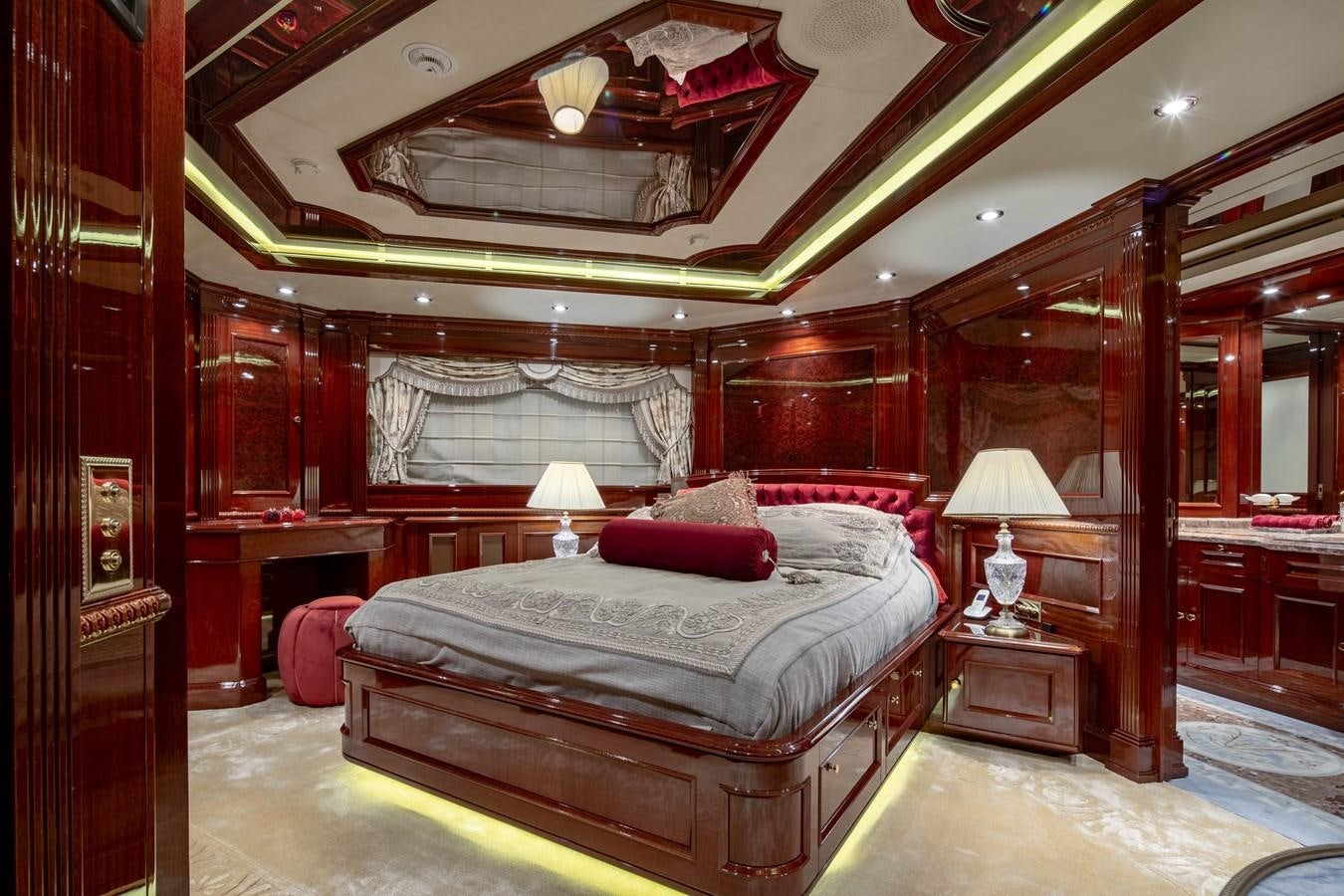 a bedroom with a bed and a mirror aboard RICHAR Yacht for Sale