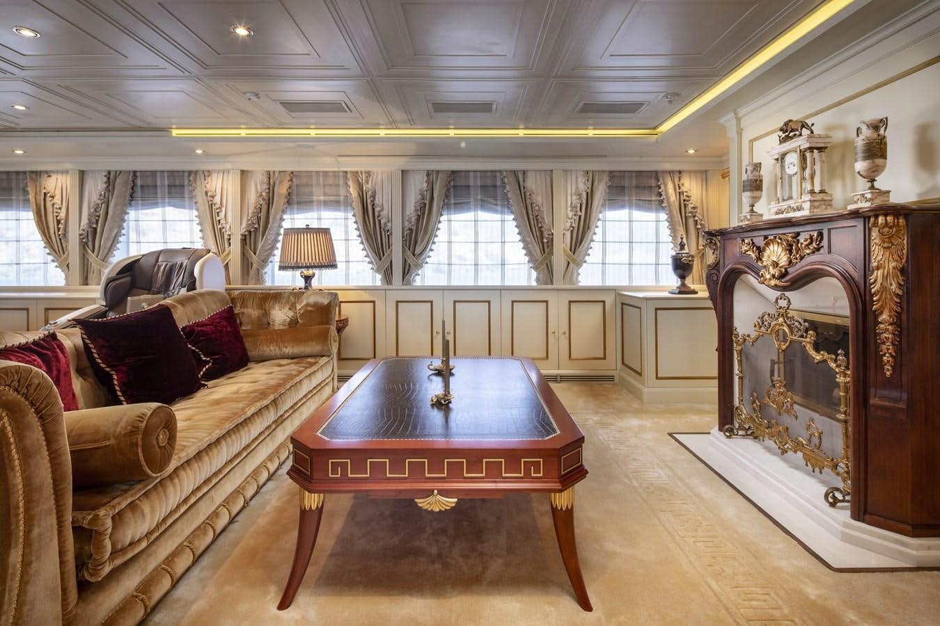 a living room with a table and couches aboard RICHAR Yacht for Sale