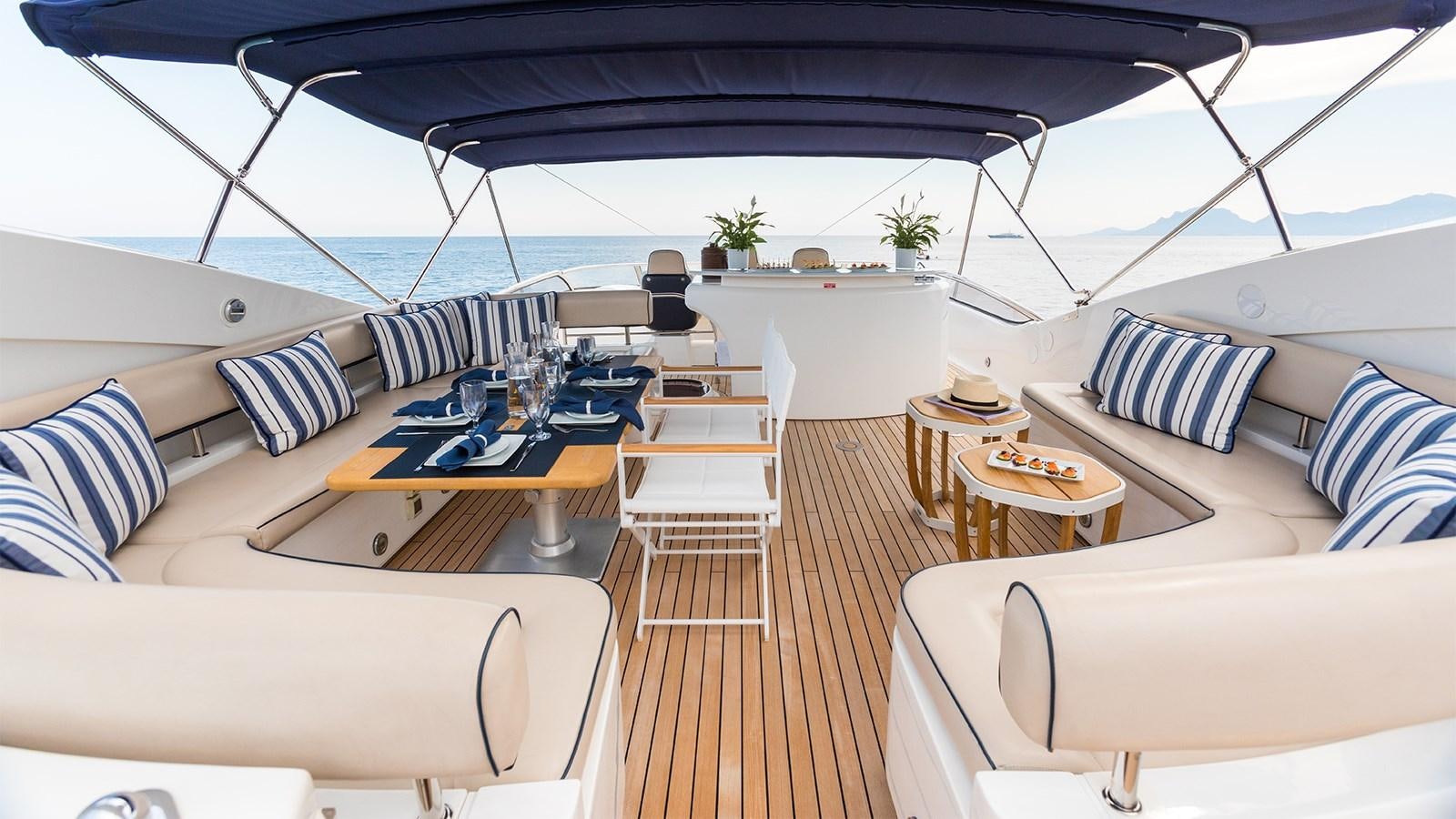 a lounge area with a table and chairs on it aboard WINNING STREAK 2 Yacht for Sale