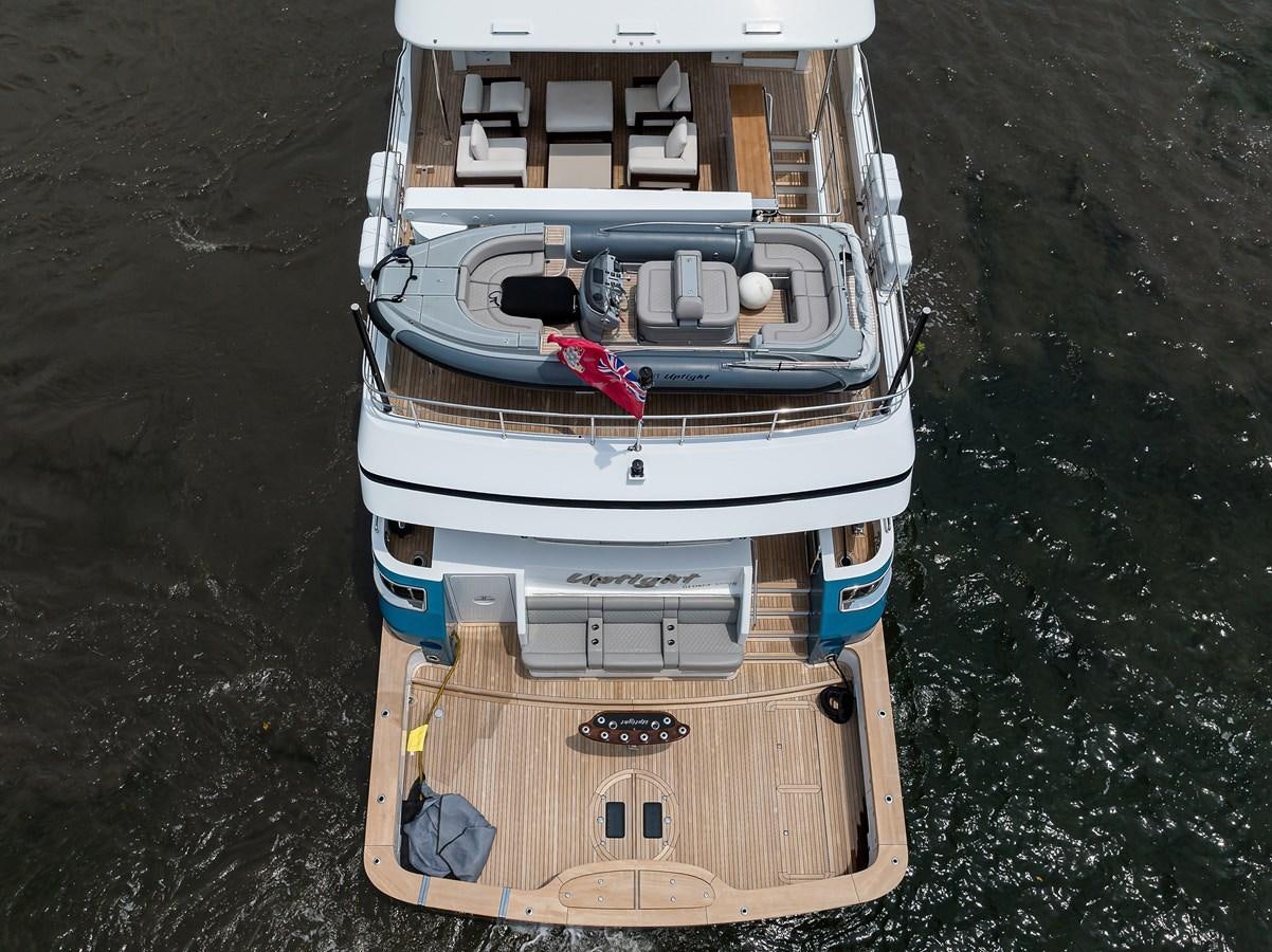 a small boat on the water aboard UPTIGHT Yacht for Sale