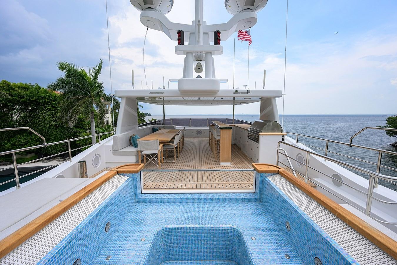 a pool with a pool and a boat in the background aboard UPTIGHT Yacht for Sale