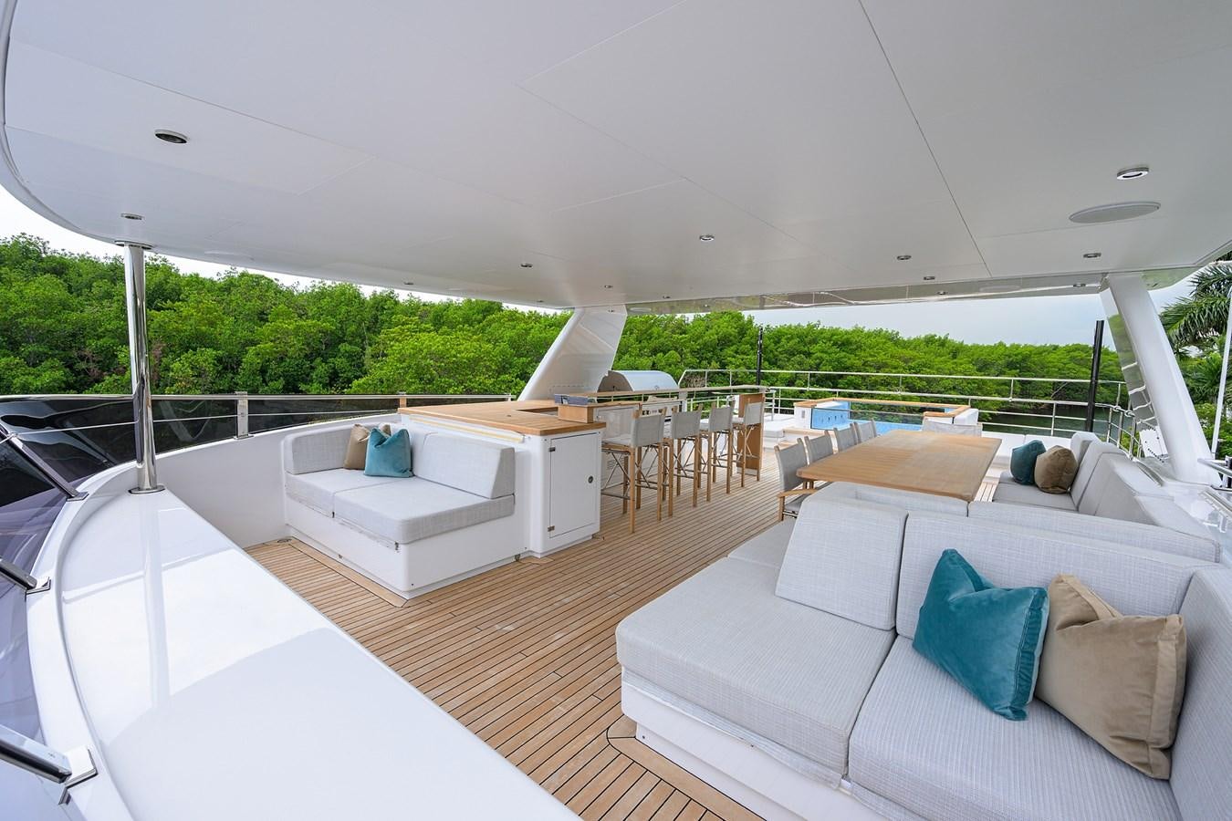 a large white lounge chair on a deck with a large white table and a large white table with aboard UPTIGHT Yacht for Sale