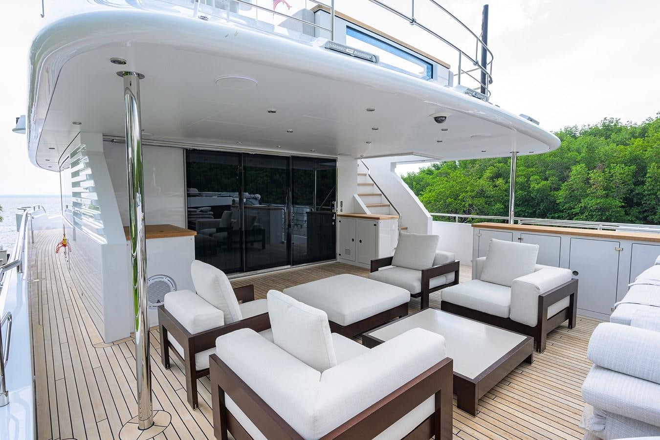 a room with a deck and chairs aboard UPTIGHT Yacht for Sale