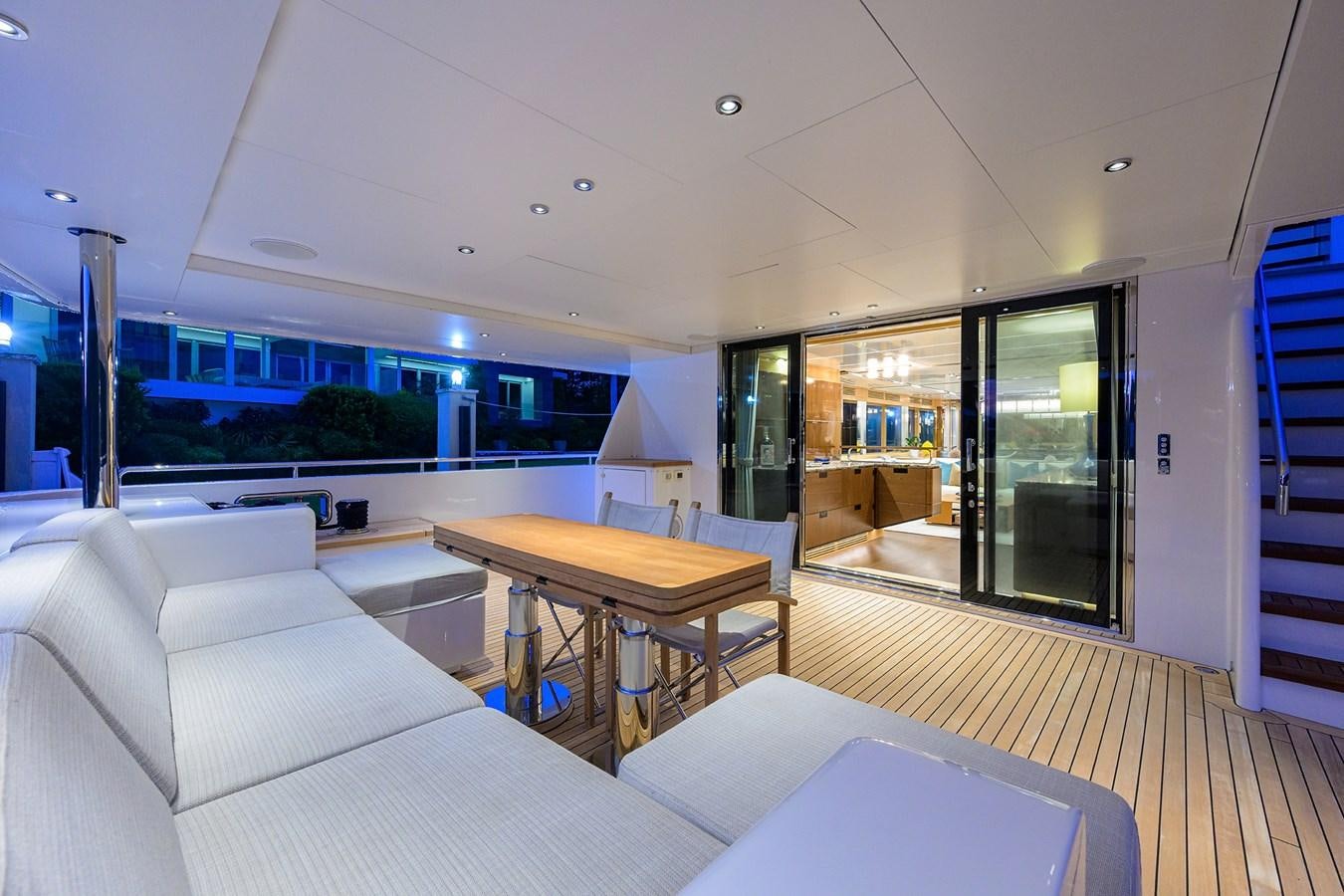 a living room with a table and couches aboard UPTIGHT Yacht for Sale