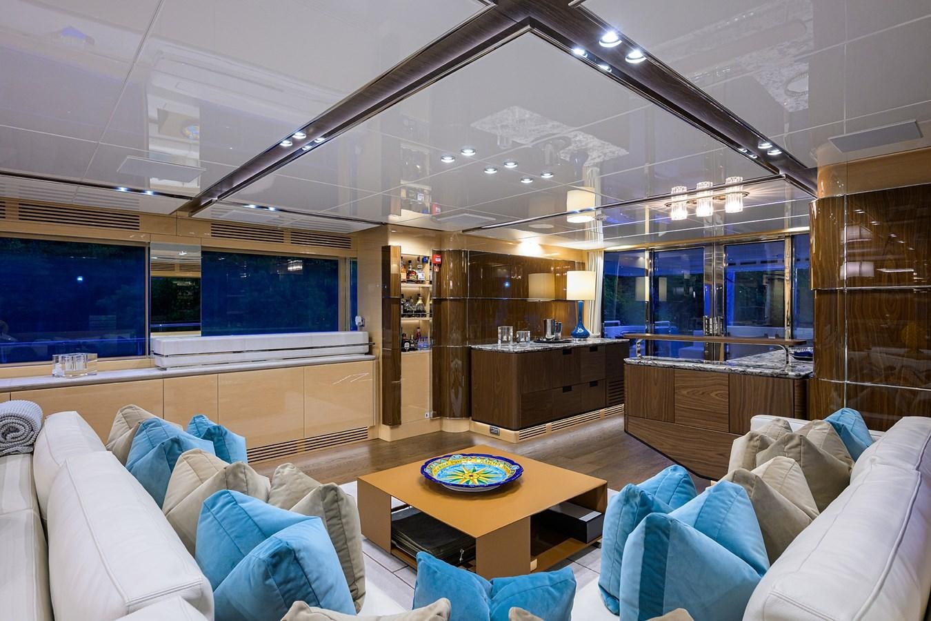 a living room with a table and couches aboard UPTIGHT Yacht for Sale