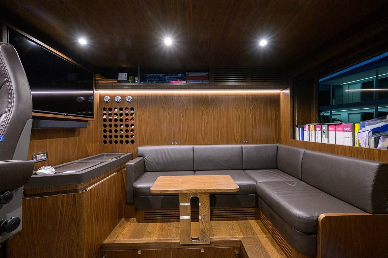 a room with couches and a table aboard UPTIGHT Yacht for Sale