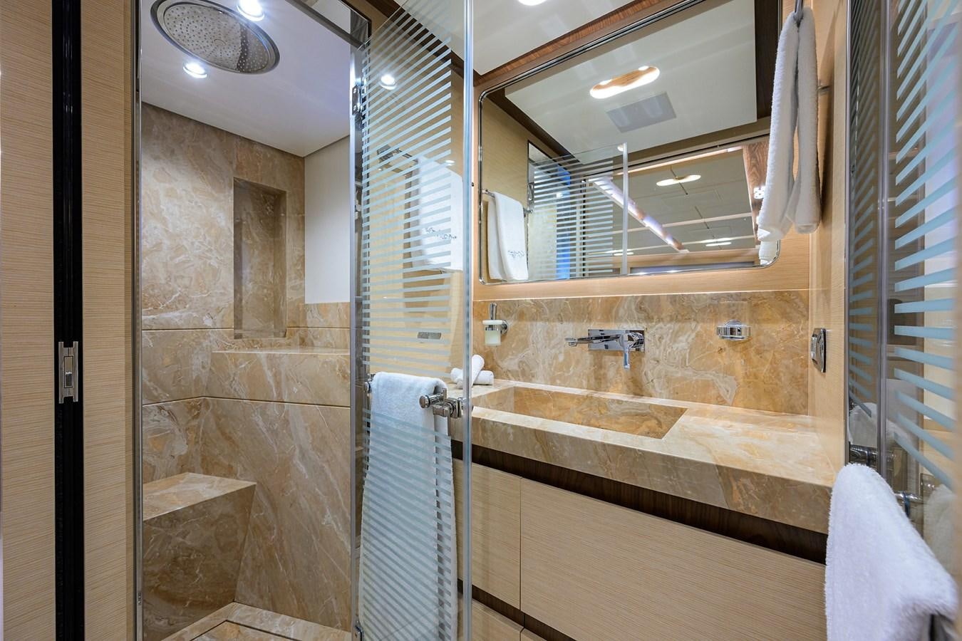 a bathroom with a glass shower aboard UPTIGHT Yacht for Sale