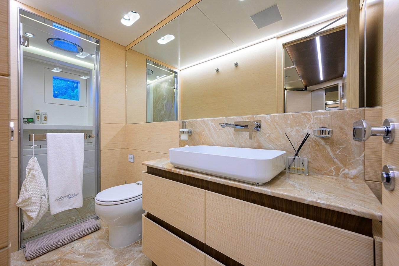 a bathroom with a sink and toilet aboard UPTIGHT Yacht for Sale