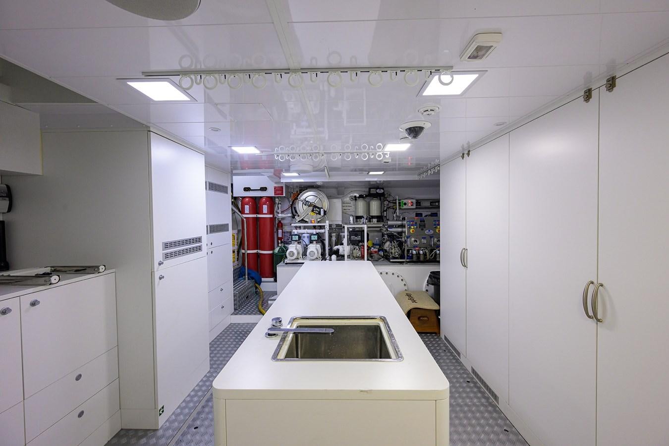 a large kitchen with white cabinets aboard UPTIGHT Yacht for Sale