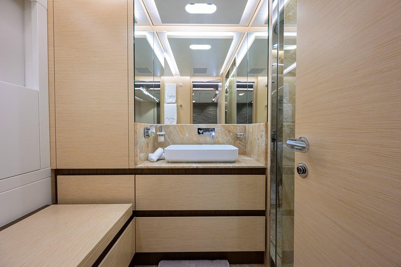 a bathroom with a sink and a mirror aboard UPTIGHT Yacht for Sale