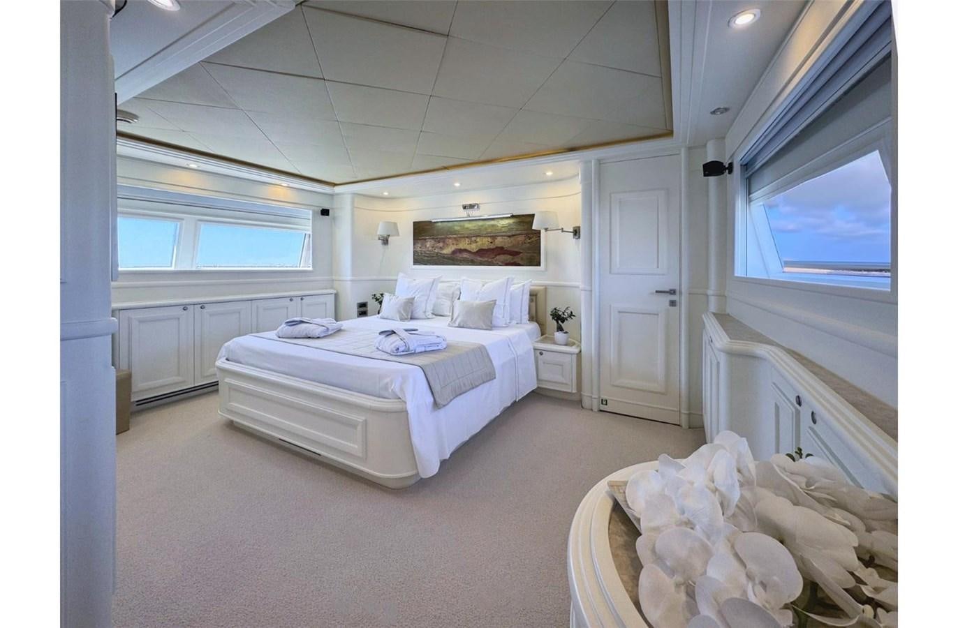 a bedroom with a bed and a chair aboard ZIACANAIA Yacht for Sale