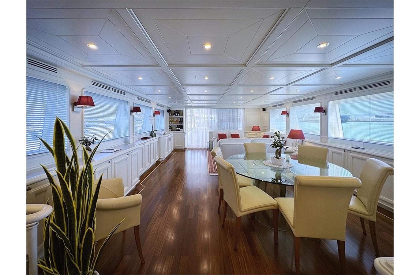 a room with tables and chairs aboard ZIACANAIA Yacht for Sale