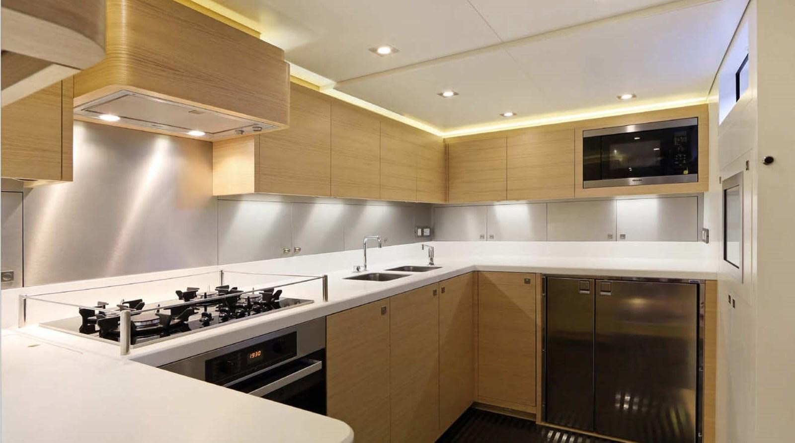 a kitchen with a stove and a microwave aboard SPIRIT OF MALOUEN X Yacht for Sale