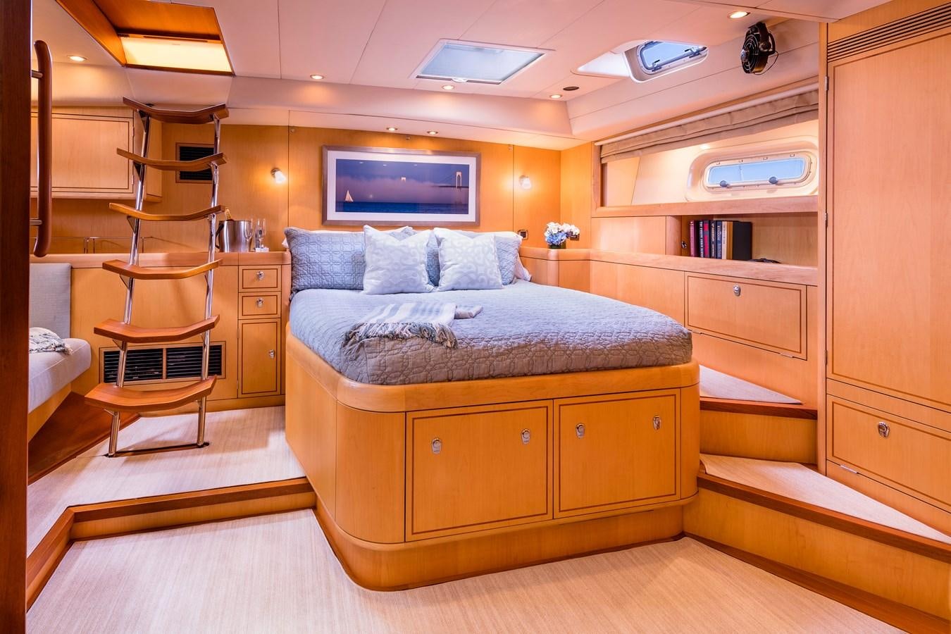 a bedroom with a bed and a desk aboard RAVENCLAW Yacht for Sale