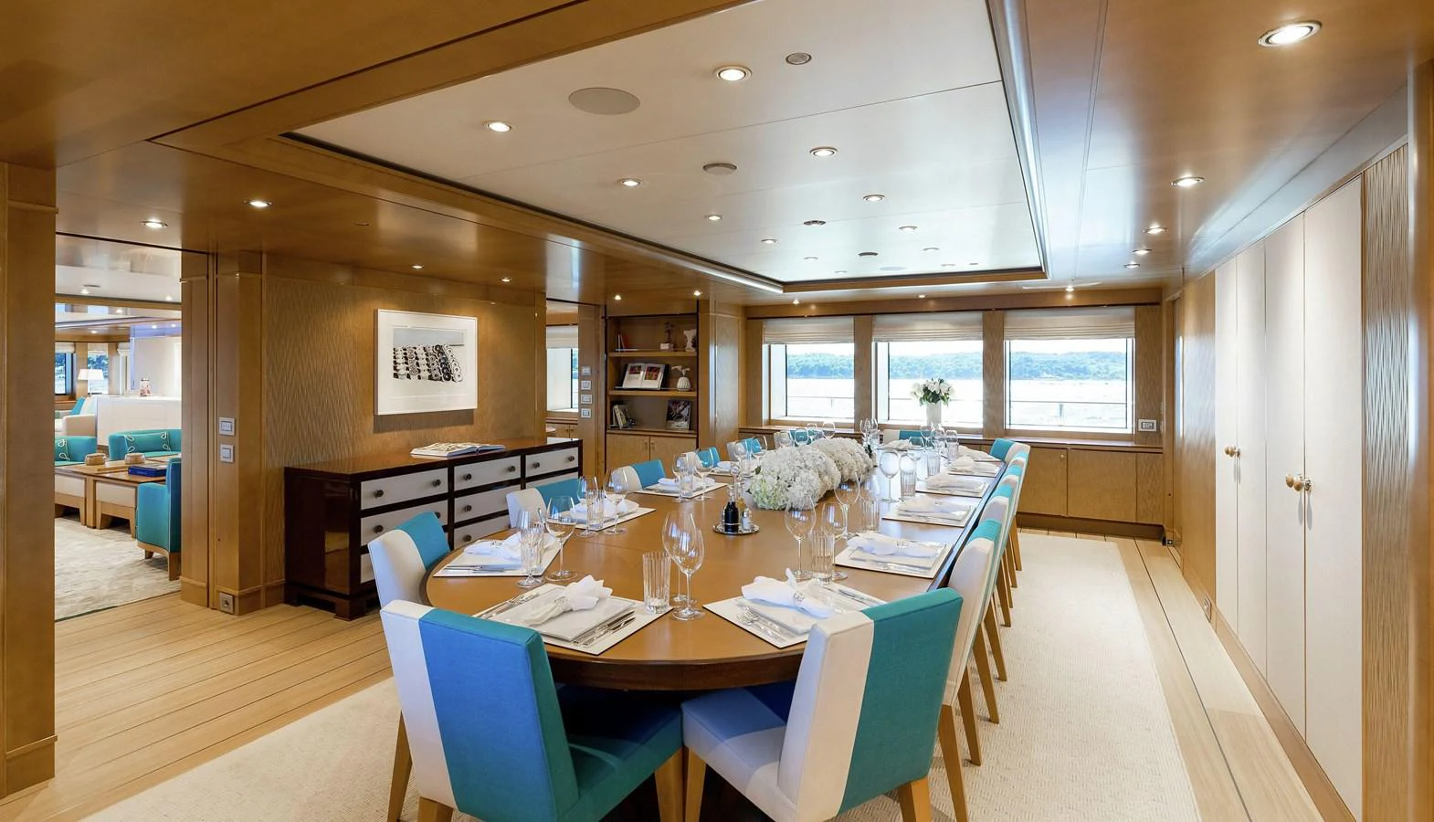 a large room with tables and chairs aboard CLELIA III Yacht for Sale