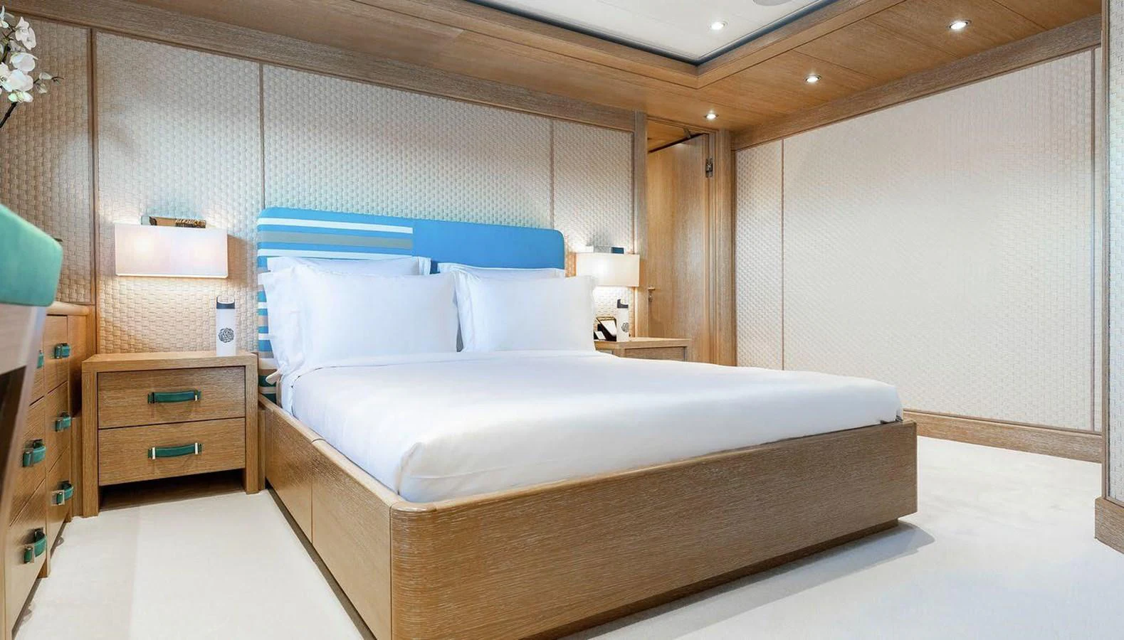 a bedroom with a bed and a dresser aboard CLELIA III Yacht for Sale