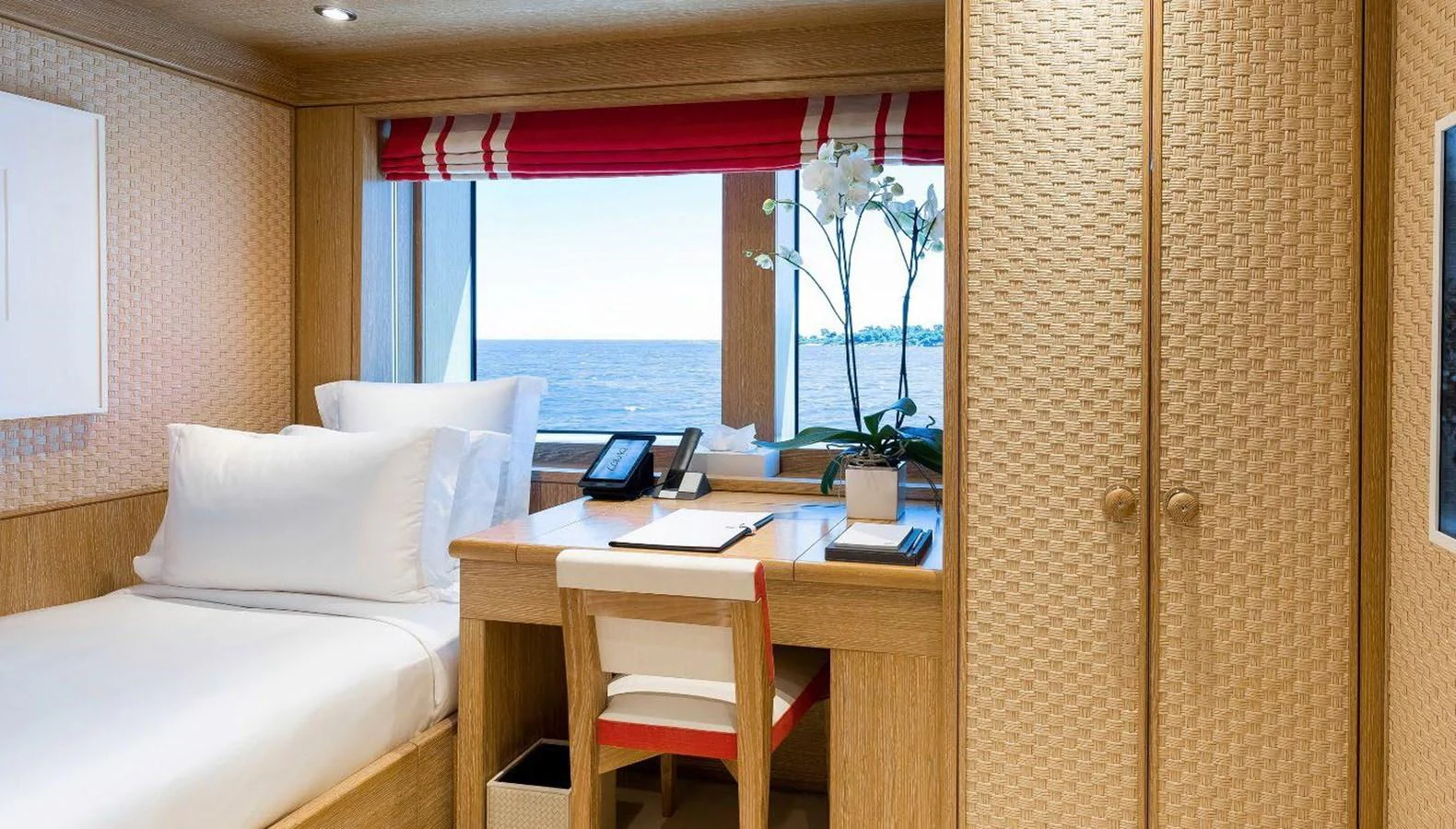 a room with a bed and a desk aboard CLELIA III Yacht for Sale
