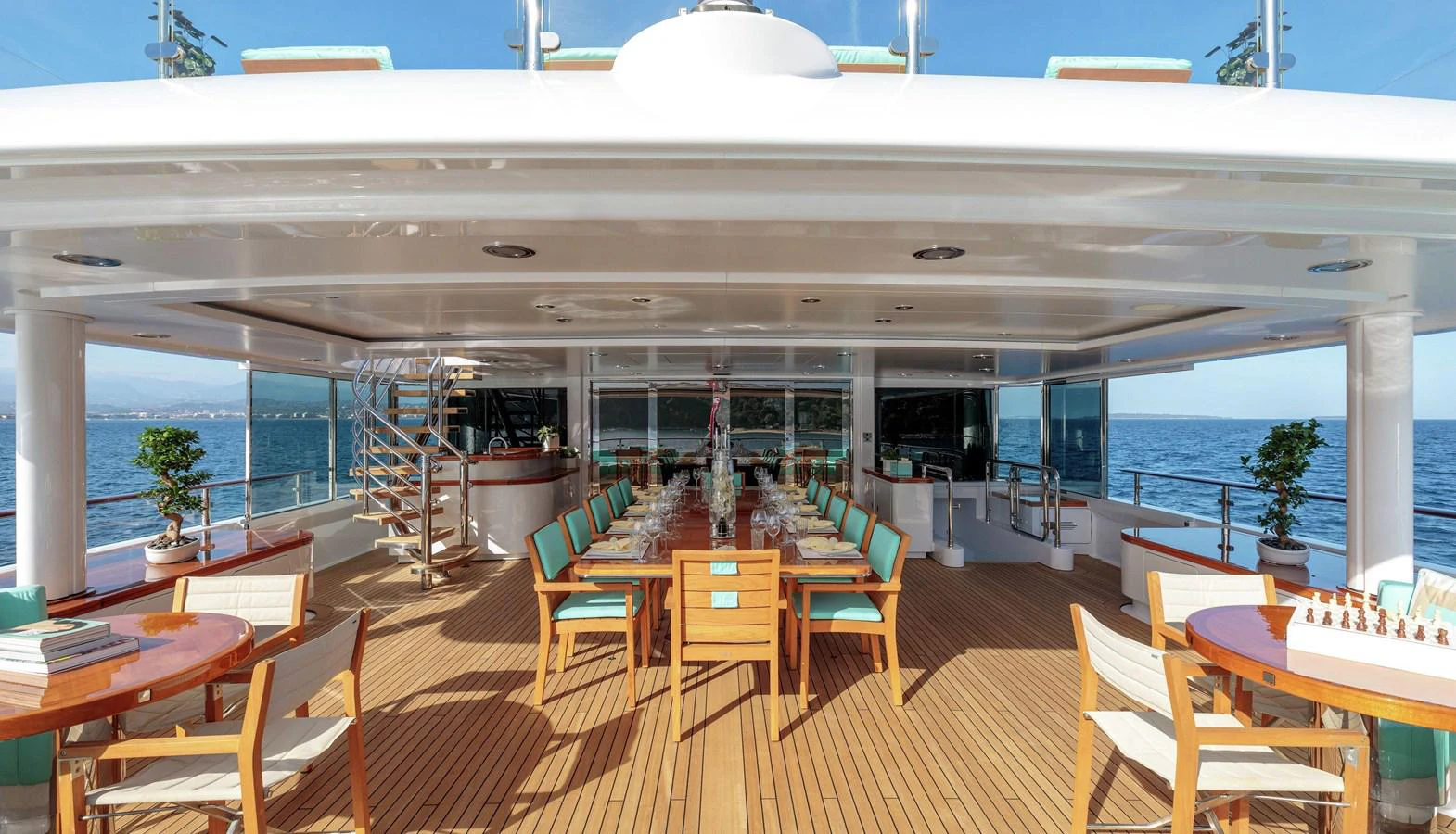 a room with tables and chairs aboard CLELIA III Yacht for Sale